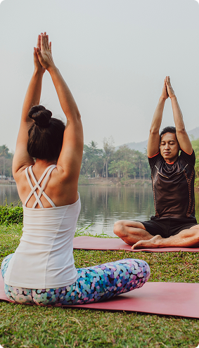 yoga-partners-sitting-with-hands-up